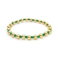 Detailed close-up of 18K gold-plated beads and green cylinder seed beads on elastic bracelet - Gold + Green