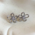 Macro detail of silver flower earrings with zircon center on ceramic tray - Silver (Silver Pin)