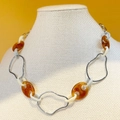 Colorful resin and silver link chain necklace in amber and ivory on display stand - Silver Base - Amber/Ivory/Grey Blue