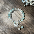 Elegant beaded bracelet with blue sea glass beads and a sparkling white butterfly pendant - S024-rhinestone Butterfly Blue Bracelet With Bursting Flowers And Sparkling Diamonds #sz207