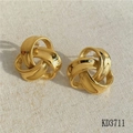 Detail of 18K gold intertwined triple ring knot earrings on a beige textured fabric - Triple Ring Intertwined Knot / Gold (KD3711)