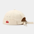 Detailed view of adjustable metal buckle and cute mushroom embroidery on canvas brimless cap - Beige