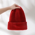 Close-up of a cozy red chunky knit winter hat with a ribbed cuff for a festive look - Knitted Slouchy Beanie / Burgundy
