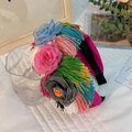 Detail of colorful fabric flower headband with vibrant multi-color silk tassels - Rose Red