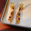 Macro detail of vintage gold earrings with amber stones in a premium jewelry box - Silver Earring Post Earrings / Gold Brown