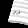 Close-up of minimalist silver star stud earrings on a white geometric display stand - Pentagram