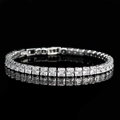 Elegant silver tennis bracelet with square-cut cubic zirconia on a reflective black surface - Single Bracelet / White