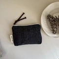 Detail view of mini denim canvas pouch with white zipper and brown braided puller - Pure Denim Blue
