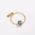 Macro detail of adjustable gold plated ring with blue oval zircon and heart charm - Blue Zirconia-Gold