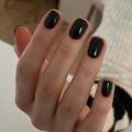 Short black glossy press-on nails with high-shine finish on hand over knitted fabric - Black (JP2641)