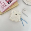 Detail view of quilted sanitary bag with rabbit pattern and light blue woven zipper puller - Multicolor Rabbit
