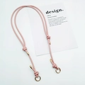 Detailed view of pink faux leather adjustable strap with gold buckles and knot design - Gold Ring Buckle / Pink