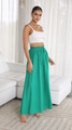 Close-up of green wide-leg trousers with high-waisted pleated details and drawstring tie - Green