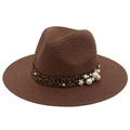 Close-up of leopard print ribbon with pearl and flower accents on a woven straw hat - Coffee
