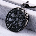 Black Viking compass pendant necklace with Nordic runes on a textured grey cushion - Pendant Only / Black