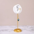 Golden earrings with blue rhombus crystal and cat-eye stone on marble display - Left Ear White