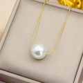 Minimalist necklace featuring a large white pearl pendant on a fine golden chain - 16mm Shell Pearl