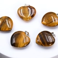 Brown tiger eye heart pendants with silver metal clasps arranged in a circle - Tiger's Eye