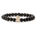Detail view of elastic bracelet with black beads and a white stone elephant charm - Glossy Black Stone Bracelet