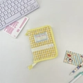 Macro view of yellow checkered quilted fabric binder with smooth zipper and textile tag - Yellow