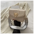 Detail of cream square bag with gold heart clasp and contrast stitch edges - Off White