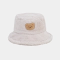 Close-up of beige faux fur bucket hat featuring a cute brown bear embroidery detail - One Size / Beige