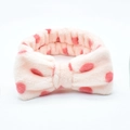 Detail of pink polka dot coral fleece headband with a soft plush bow for face washing - Light Pink Polka Dot
