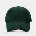 Close-up of distressed ripped details and cotton canvas texture on dark green baseball cap - Dark Green