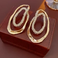 Macro view of gold-plated oval earrings with sparkling zircon crystals on a jewelry box - Irregular Double Loop Rhinestone Style / Gold Plated (S925 Silver Needle)