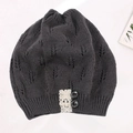 Detailed view of grey knitted beanie featuring leaf openwork pattern, lace trim, and buttons. - Adjustable / Dark Gray