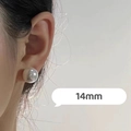 Macro view of a 14mm large white pearl stud earring worn on the earlobe - 14mm