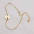 Golden delicate chain bracelet featuring a round pendant with the letter V engraving - Gold V