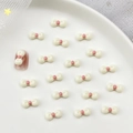 Cute resin 3D cream bow charms with pink centers for DIY nail art and press-on nail decor - Beige