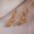 Elegant gold leaf earrings with sparkling zircon accents on a soft fabric background - Gold Leaf Style