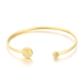 Elegante brazalete de acero dorado con diseño de rayos de sol y detalles de circonita - Dorado