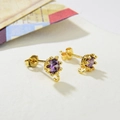 Detailed macro of gold crown earrings with purple zircon and integrated small hook - Gold Purple Zirconia