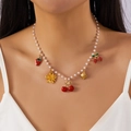 Detail of beaded pearl necklace with colorful strawberry and cherry pendants on a model - Pearl Beaded Strawberry Cherry Flower Sweet Pendant Necklace