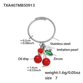 Roestvrijstalen ring met kersen hanger van rood emaille en groene zirkoon steen - Ring / US 7 / Staalkleur