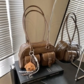 Vintage coffee brown glossy shoulder bag with twin front pockets and teddy dog charm - Brown