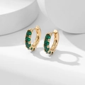 Polished gold huggie hoop earrings with five sparkling green zircons in a minimal design - Green Zirconia