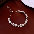 Detailed macro view of adjustable silver bracelet with crystals on red silk - White