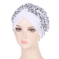 Detail of white velvet turban cap with shimmering silver sequins on a mannequin head - White