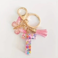 Pink resin letter T keychain with colorful hearts, pink tassel and butterfly charm - Letter T