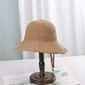 Minimalist straw sun hat in light khaki with adjustable chin strap on wooden stand - M (56-58cm) / Camel
