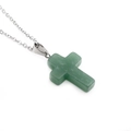 Detailed shot of cross pendant necklace featuring green semi-precious stone and silver chain - Green Aventurine Cross