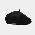 Close-up of black wool beret featuring a vintage brown leather label with LOVE STYLE text - Black