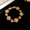 Bracciale vintage dorato con cristalli color ambra e strass bianchi dal design circolare - Champagne