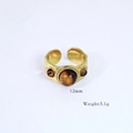 Detailed macro shot of vintage 14k gold plated tiger eye ring with 12mm center stone - Tiger Eye Three Stones Design Style