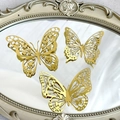 Three golden hollow metal butterflies displayed on a vintage carved mirror frame - Style 2 / Set of 12 / Gold