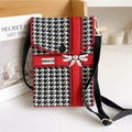 Detail of red and black knit crossbody bag featuring houndstooth pattern and Grace label - Bow Houndstooth Red